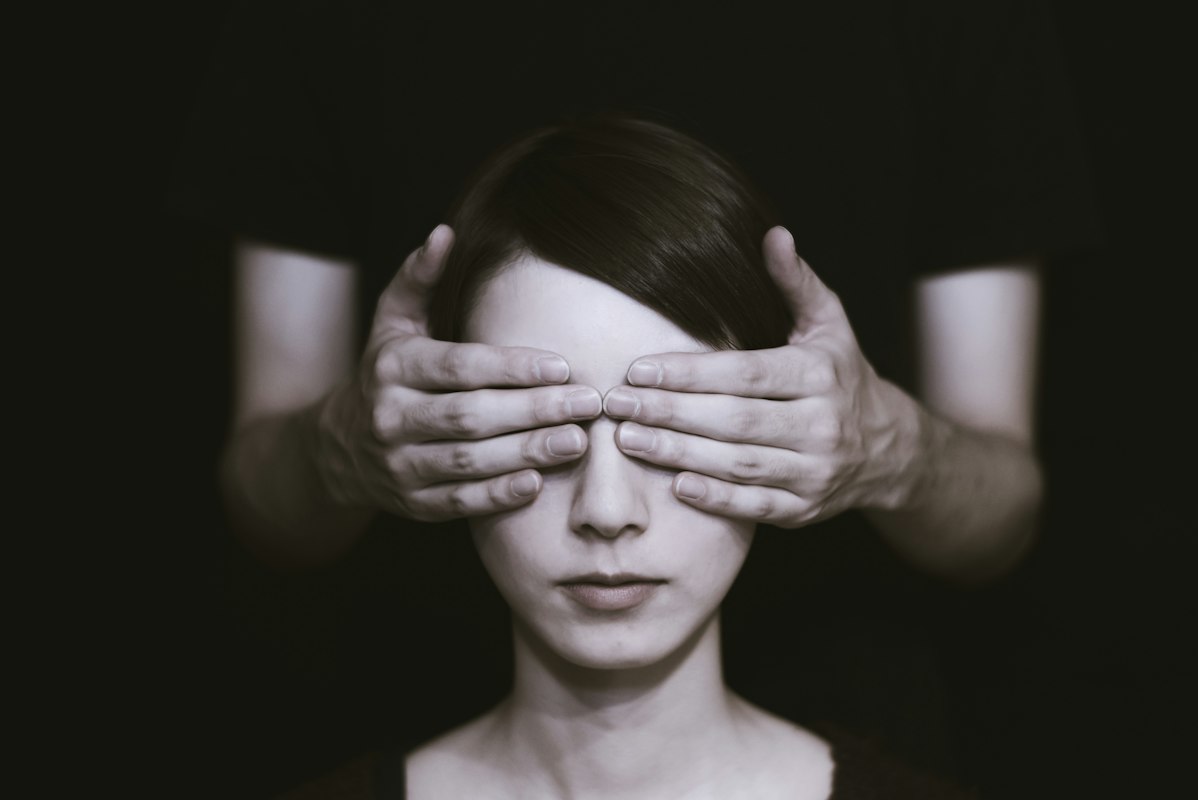 Woman performing morning eye care routine with warm compress