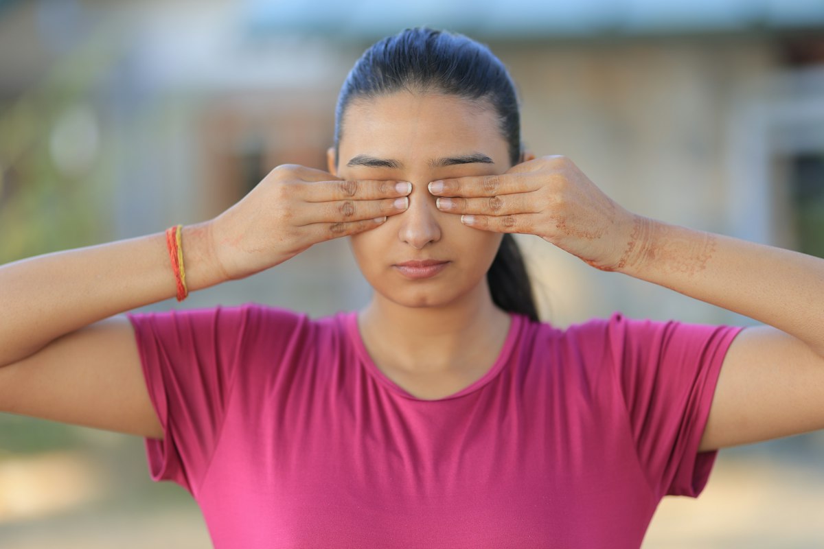 Person doing eye exercises and palming technique